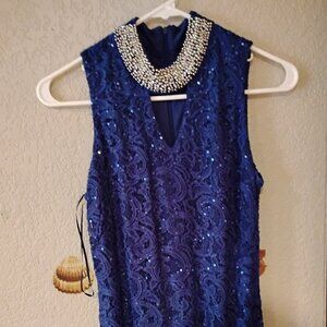 A sparkly blue dress with a beaded collar